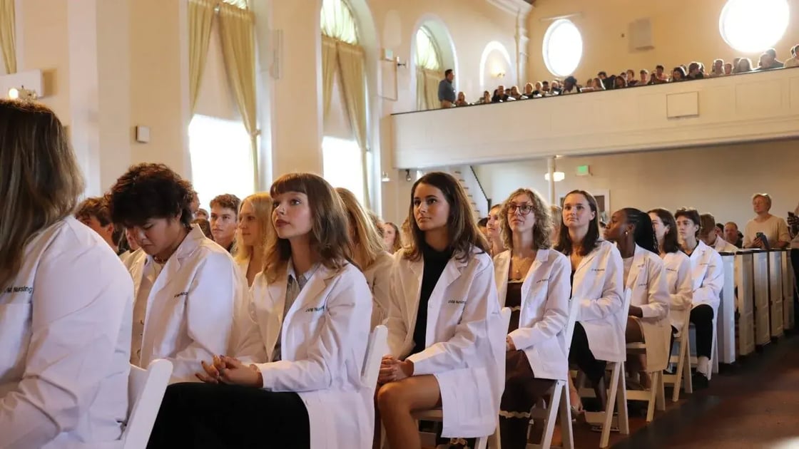 UVM nursing students sit in the audience after receiving their white coats in Ira Allen chapel.