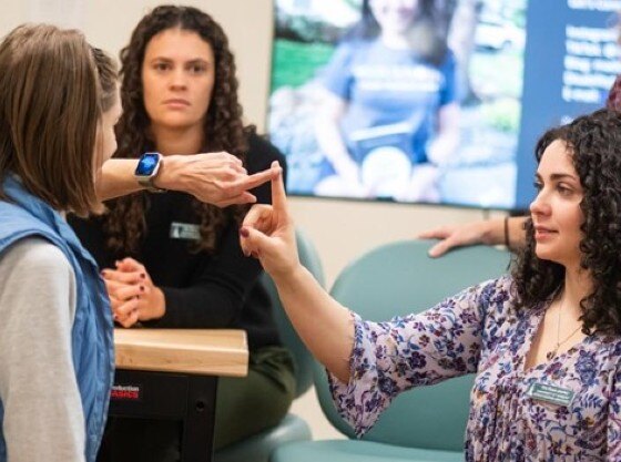 Occupational therapy students with a client in the lab