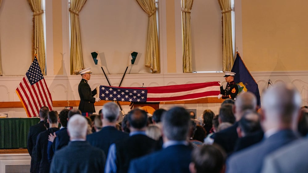 Two Marines unfurl and American flag in the Ira Allen Chapel to honor Jarlath O'Neil-Dunne