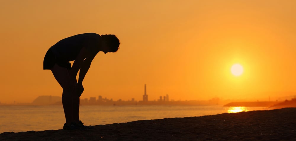 PHOTO-A man exercising along an urban waterfront bends down due to the extreme heat-iStock-000031433304-041321-1440x950-landscape